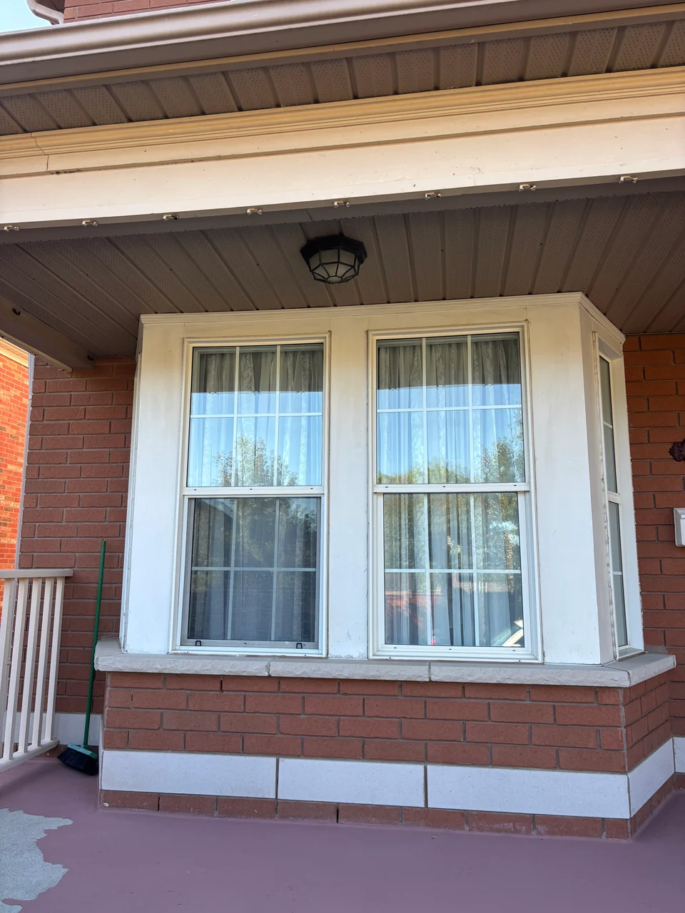 Before: porch window trim and wood ceiling beside a brick wall