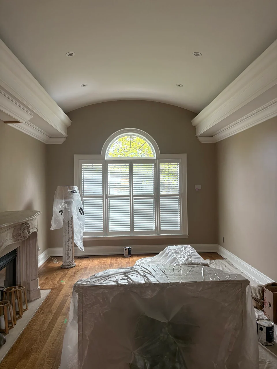 After: light neutral walls and barrel ceiling above a shuttered window
