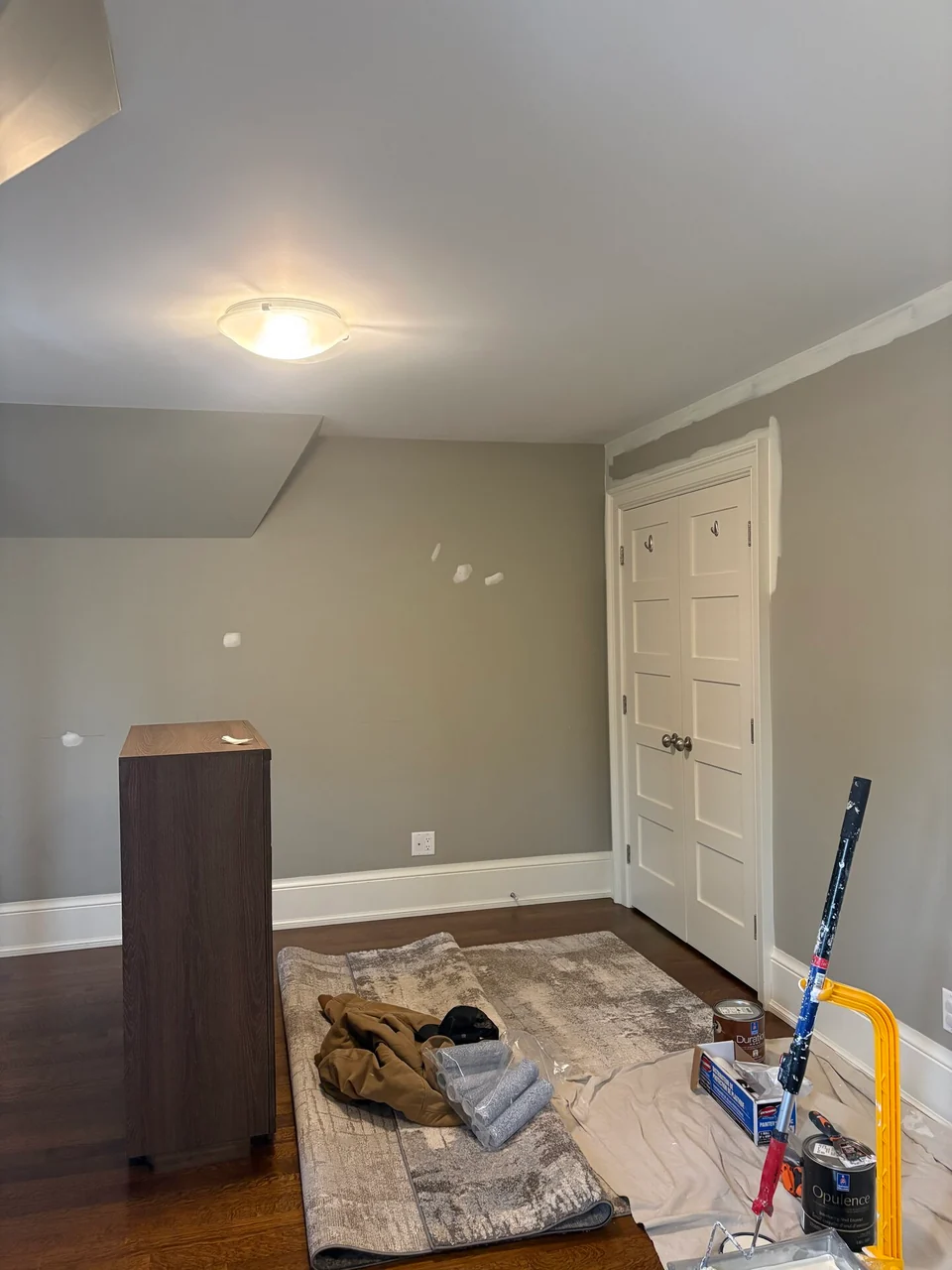 Bedroom preparation with wall patches and protected wood floor