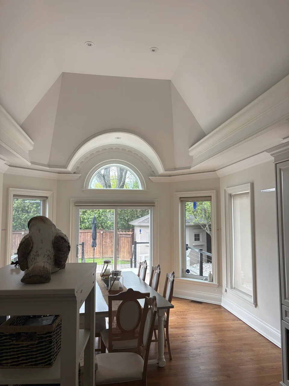 Finished white domed dining room ceiling with detailed crown moulding