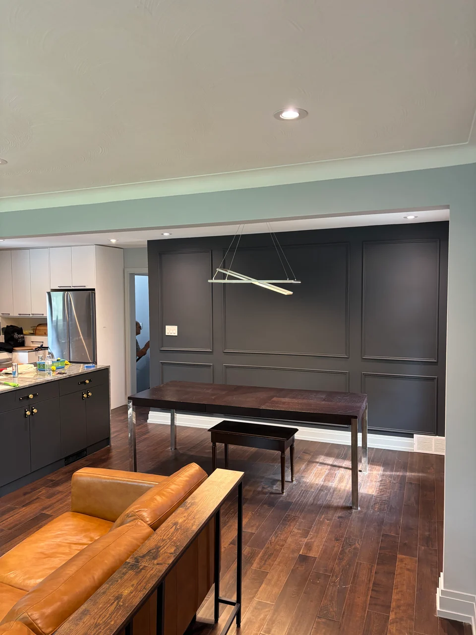 After: dark charcoal panelled living room wall with contrasting white trim