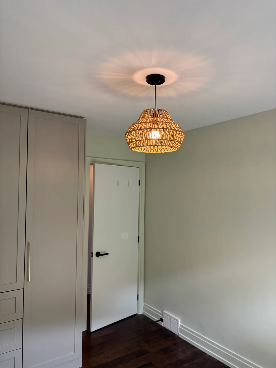 After: pale room walls with white door and fitted wardrobe