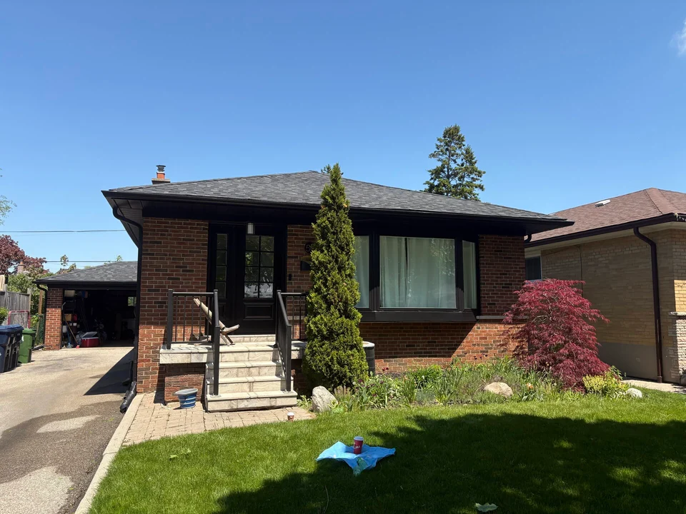 Finished black soffit and porch trim across the brick bungalow front