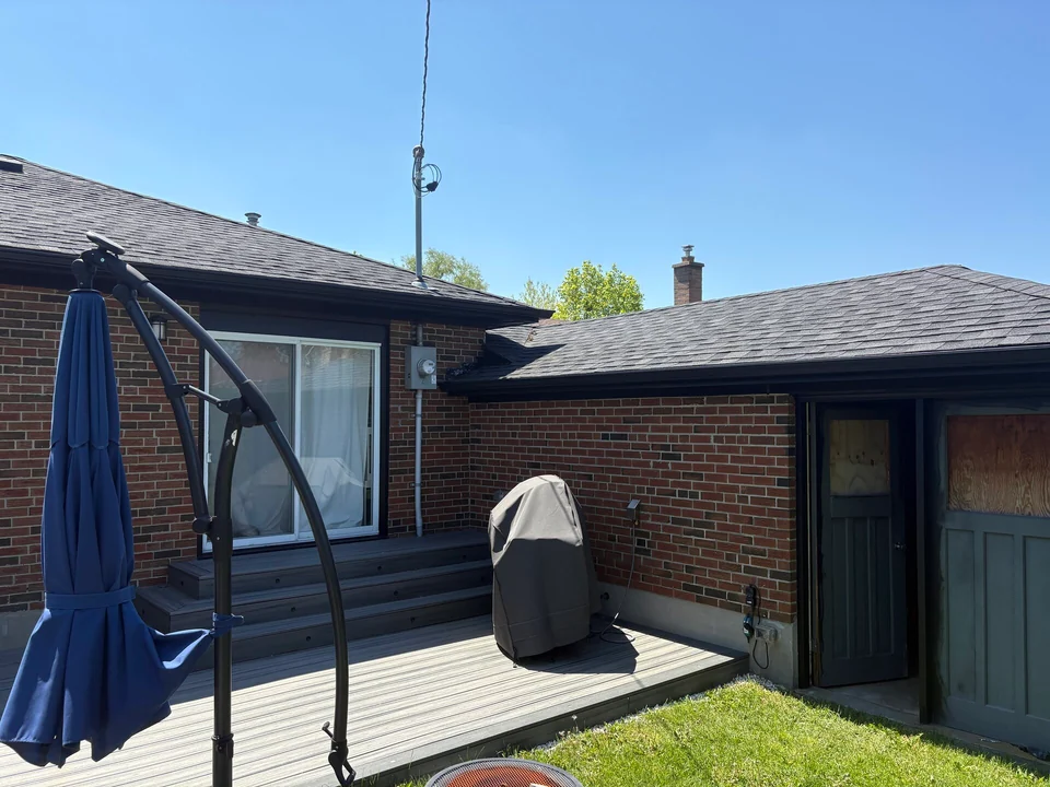 After: black fascia and trim around the rear patio and garage